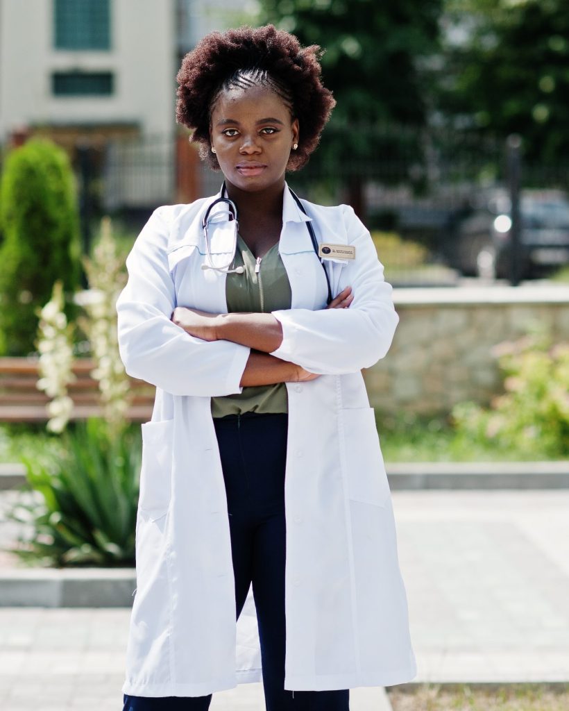 African american doctor female at lab coat with stethoscope outdoor.